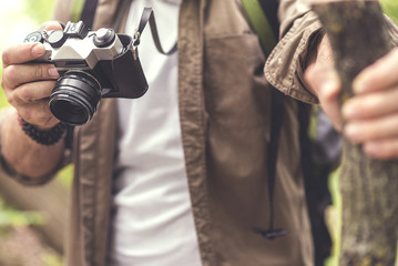 Senior man taking photos in forest