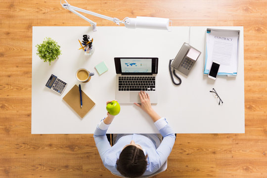 Businesswoman With Apple And Laptop At Office