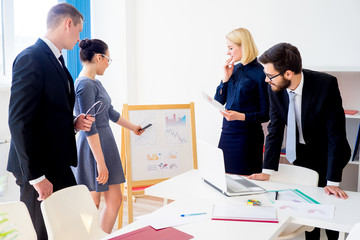 Businesspeople study diagrams