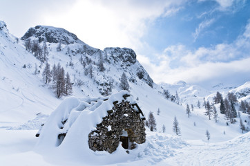 Mountain hut made of stones - shelter for mountaneers from the snow storm in winter, mountain...