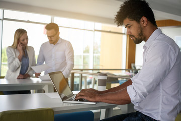 Fototapeta premium African American business man using computer at the office. African man working on laptop. Business people in office.