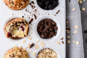A set of products for the preparation of muffins. Muffins with blackberries and chocolate.