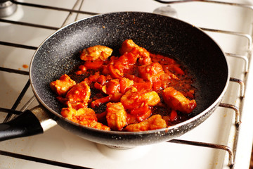 Stewed meat in tomato sauce in the pan