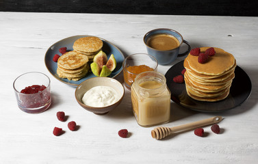 Fluffy cottage cheese pancakes with honey, jam, yogurt and fresh fruit