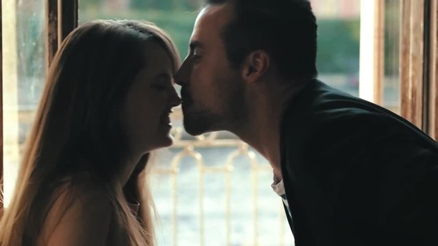 Lovers sitting face to face. Love games on a romantic date on a summer day