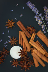 Obraz premium Sense of Spices cinnamon and star anise whit candle on black background with copy space