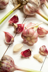 Fresh garlic on a white wooden table.