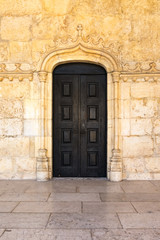 Fototapeta na wymiar Medieval Portuguese Door Black Closeup Architectural Feature Warm Temperature