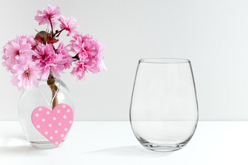 Mockup - stemless wine glass, next to blossom in a vase, perfect for businesses who sell decals and stickers, just overlay your designs