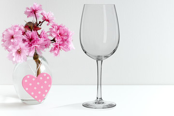 Mockup - wine glass, next to blossom in a vase, perfect for businesses who sell decals and stickers, just overlay your designs