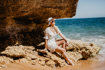 Side view of beautiful beauty woman on the cave beach of ocean coast. © dianagrytsku