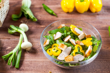 chicken salad bowl on kitchen table, balanced diet