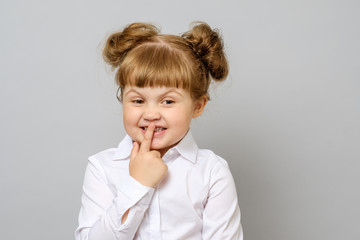 Girl covering her mouth with her finger