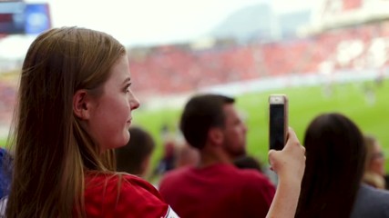 Happy Sports Fan Takes Smartphone Video Of Her Favorite Professional Soccer Team Playing In Stadium