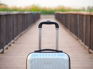 Travel luggage on wooden bridge background, travel bag