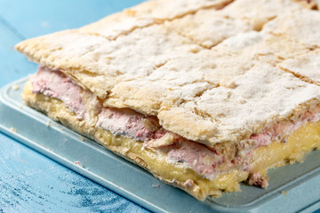 Raspberry cream pie on the table sliced in to pieces