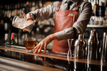 Barman making alcohol cocktail. No face
