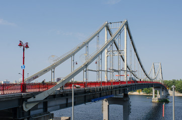 Pedestrian Park Bridge to the Truhaniv Island in Kiev, Ukraine, on a sunny summer day
