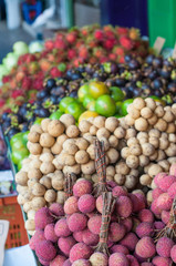 Asian Thai fruit lychee orange and rambutan sales on foot path.