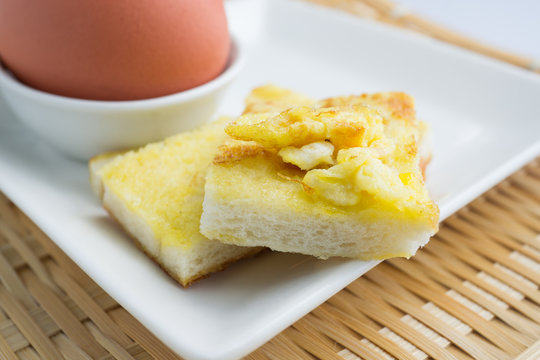 square egg bread in white square plate on bamboo mat background