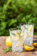 refreshing lemonade drink with rosemary in glasses