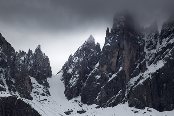 Cloudy snowy mountains peaks landscape. Dolomites Alps