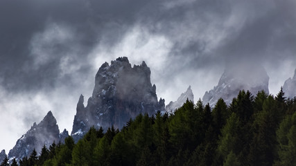 Cloudy snowy mountains peaks landscape. Dolomites Alps