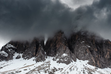 Cloudy snowy mountains peaks landscape. Dolomites Alps