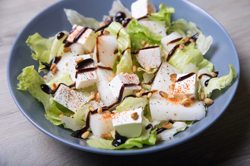 Salad with feta cheese, melons and cedar nuts. Selective focus.