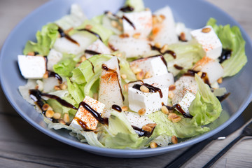 Salad with feta cheese, melons and cedar nuts. Selective focus.