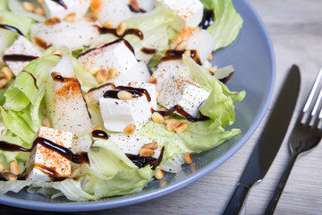 Salad with feta cheese, melons and cedar nuts. Selective focus.