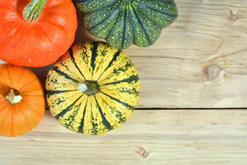 Pumpkins and squashes on wooden background