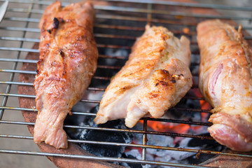 Grilling delicious pork on barbecue charcoal grill.