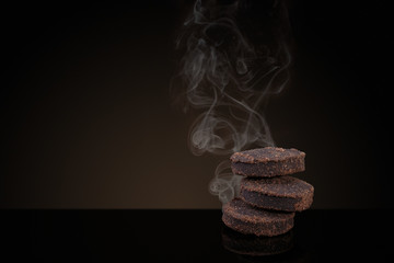 Incense of Traditional Arabian Fragrance Oudh Bakhoor smoking on black background - obrazy, fototapety, plakaty
