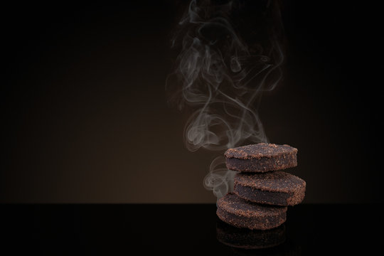 Incense of Traditional Arabian Fragrance Oudh Bakhoor smoking on black background