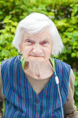 Elderly woman listening to music with headphones