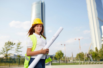 Young female architect/construction engineer at a construction site