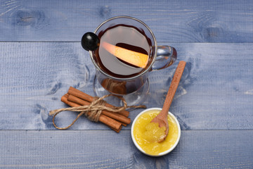 Mulled wine with orange slice, honey and bunch of cinnamon