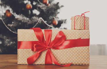 Christmas presents on decorated tree background, holiday concept