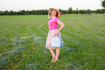 Fototapeta premium portrait on cute funny laughing or surprised woman with backpack and hat
