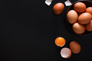 Brown and white organic eggs on wood background