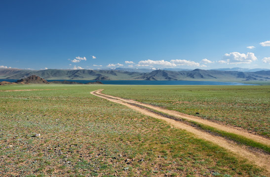Mongolian natural landscapes with country road to the lake Tolbo-Nuur in north Mongolia