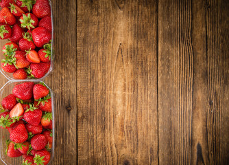 Portion of Strawberries on wooden background, selective focus