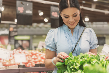 Beaming asian customer buying herbs in shop