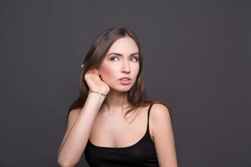 Fototapeta premium Young woman trying to listen gossip
