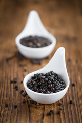 Wooden table with preserved black Peppercorns