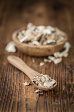 Portion of Dried Mushrooms on wooden background, selective focus