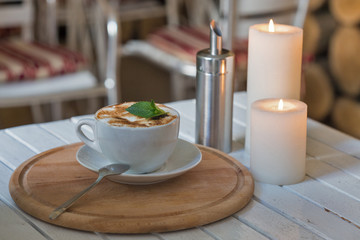 Coffee cup and romantic candles closeup