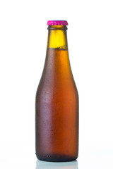 Bottle of beer with drops isolated on white background