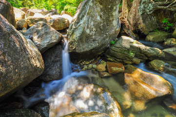 Fototapeta na wymiar The soft stream is flowing through the rocks.